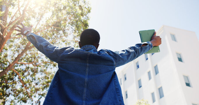 Man, student and tablet in city with freedom, academic achievement or scholarship opportunity. Back, low angle or person outdoor with tech for university acceptance, success or funding grant to study