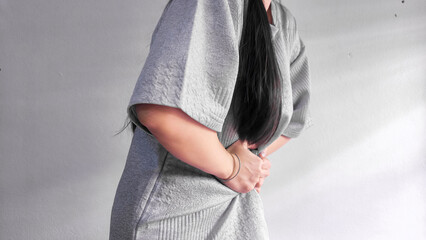 Woman holding stomach in pain, abdominal pain and stomach ache concept