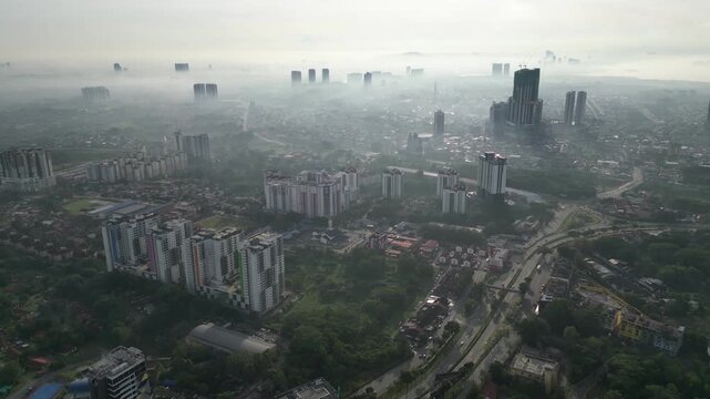 A city with a lot of buildings and a lot of traffic. The sky is hazy and the sun is not visible. Aerial view Larkin, Johor