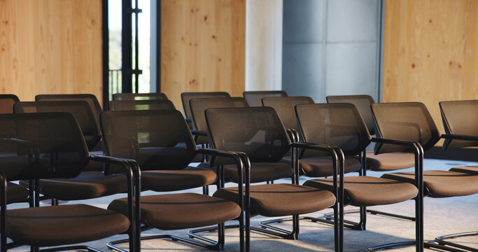 Chairs, seminar and empty room for business forum, event and convention or meeting venue. Furniture, hall and interior of conference center with rows for summit, presentation or seats for workshop