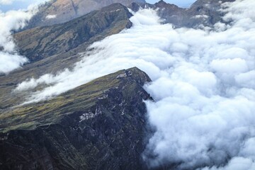 Ethereal Sea of Clouds Rolling Over Rugged Mountain Ridges