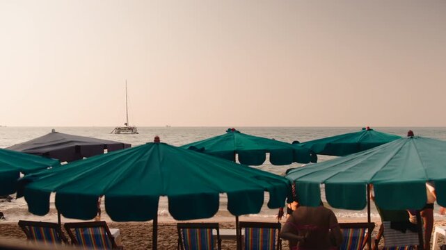 People relaxing on pattaya beach with umbrellas