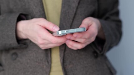 Close-up view of attractive young caucasian woman's hands using smartphone online checking social media making internet payments. Focused modern adult female typing texting scrolling on phone outside. - Powered by Adobe