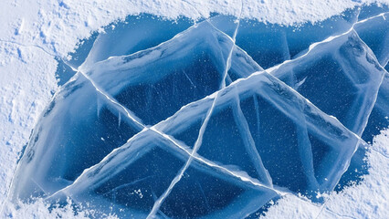 Abstract Close-up of Deep Blue Cracked Ice Surface with Snow and Light Reflections