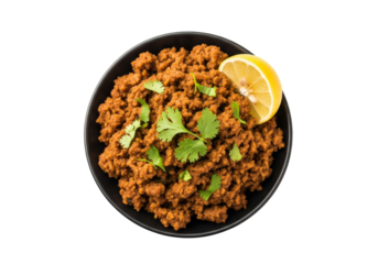 spiced minced meat curry with cilantro and lemon in a black bowl - top view