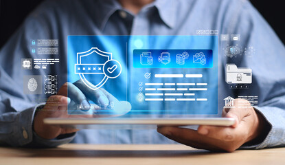 Close-up of businessman using digital tablet with hologram security lock icon. Concept of cybersecurity, data protection, encryption, AI technology, and online privacy.