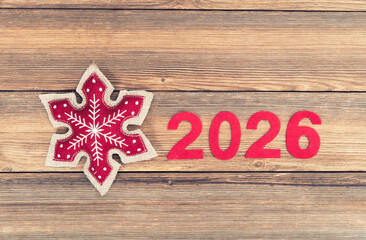 shape of snowflakes christmas decoration with 2026 on wooden background