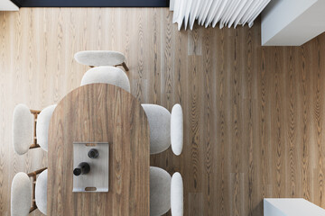Top view of a modern wooden dining table and fabric chairs on parquet floor, 3D rendering