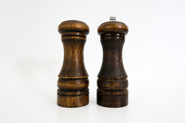 Dark brown wooden classic salt and pepper shakers isolated on white background, front view