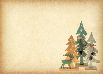 Deer on skiing, three fir trees made of plywood on Old antique vintage paper background.