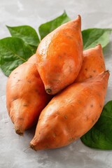 Fresh sweet potatoes with green leaves
