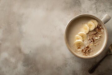 Creamy bowl filled with oatmeal topped with banana slices and nu