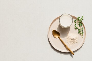 Creamy beverage paired with powdered supplement on minimalistic