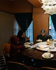 Shanghai, China - December 8, 2024  Muslim kids dining at Kadeer Muslim Restaurant, modern interior.