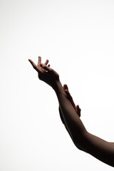 A pair of hands posed gracefully in mid-air against a clean white background, conveying motion, elegance, and artistic expression. Includes copy space