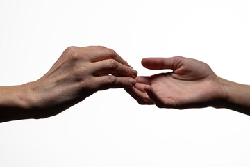 Close-up of two hands gently approaching touch, symbolizing emotional connection, empathy, or care, set against a white background with copy space