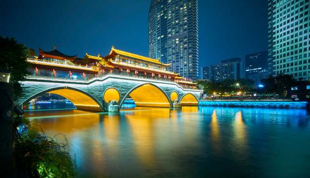 Beautifully illuminated Anshun Bridge reflecting in the Jin River