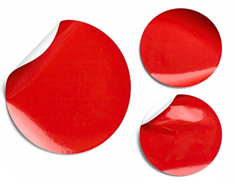 Three red circular stickers, some peeled
