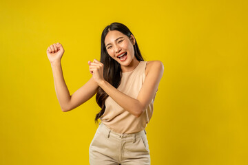 Portrait of Asian beautiful woman standing in isolated yellow background. 