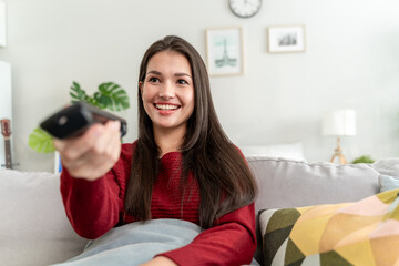 Mixed race beautiful woman watching romantic movie on television at home. 