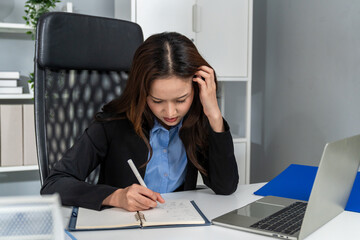 Frustrated Asian young businesswoman overwork late in office workplace. 