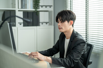 Asian attractive businessman employee working in the office workplace. 