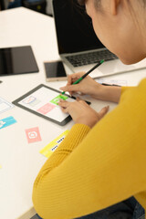 Creative web designer planning UI application and developing digital template