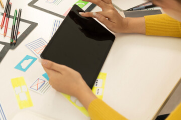 Creative web designer planning UI application and developing digital template