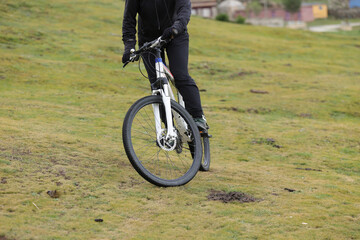 Riding mountain bike on grassland mountains