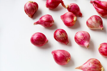 Red shallots on white background.
