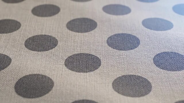 Close up view of gray polka dots pattern on fabric texture surface