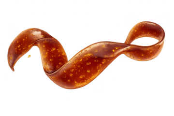 Swirling liquid amber ribbon on transparent background close-up view.