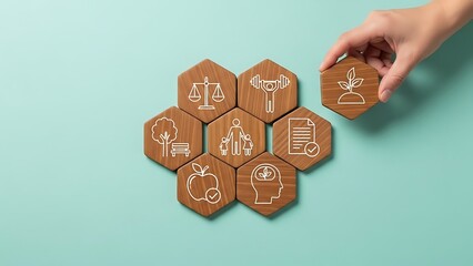 Hand placing a wooden hexagon with a plant icon on a set of interconnected hexagons