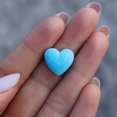 Blue Heart-Shaped Candy on Hand