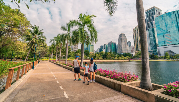 Family visiting in Benjakitti park in Bangkok, backview