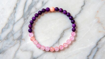 Colorful bead bracelet on marble surface with round and smooth shapes arranged in a circle