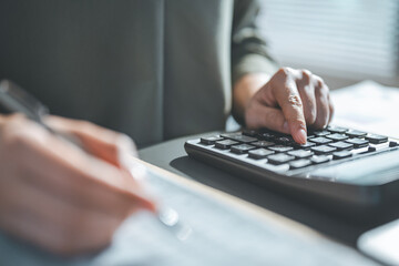 Close-up of hands using a calculator for financial analysis and accounting work, representing budgeting, audit, bookkeeping, and business finance management with accuracy.