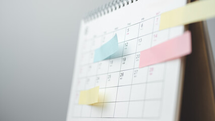 Savings goal and financial milestone concept using a calendar with sticky notes to represent budgeting, progress tracking, emergency fund planning, and long-term personal finance management.