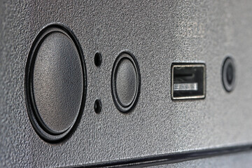 Close-up of computer case panel with USB port, power button and reset icon