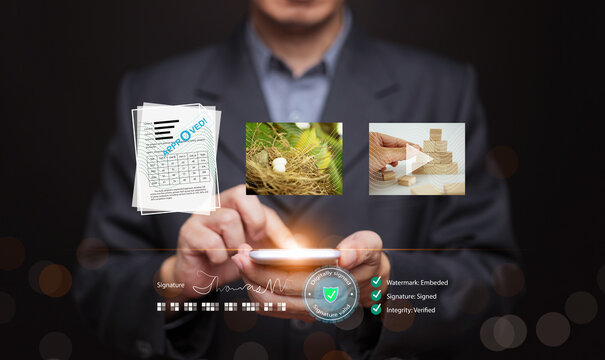 Businessman using a smartphone to access verified digital documents, nature image, and business concept video. Online asset protection, trusted approval, secure data, fle management system,