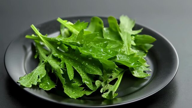 Fresh Rucola Leaves On Black Plate