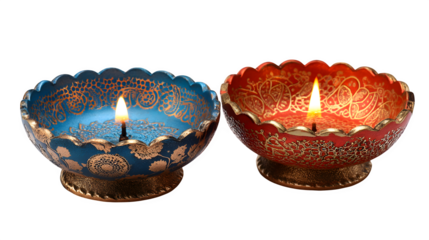 Two burning candles in a candlestick and a single candle in a glass glow with a warm flame, creating a romantic holiday decoration illuminated against the dark night