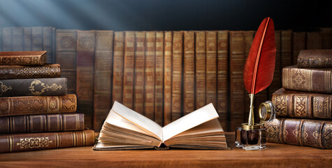 Old books ,quill pen and vintage inkwell in old library. Conceptual background on history,...