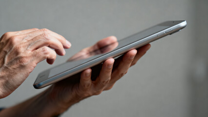 Close-Up of Hands Using Tablet Device, Modern Technology Concept © zhang
