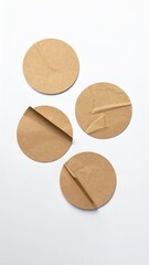 Brown paper circles, some wrinkled, on white
