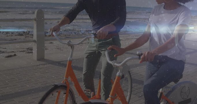 Woman and male bicyclists adjusting handlebars and gesturing toward path, starting travel cycling