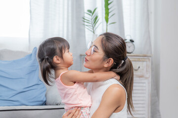 Asian mother take care adorable child hurt on knee with bandage, naughty kid getting wound fall while running, kid's medical insurance planning against sickness and accidents, healthcare lifestyle