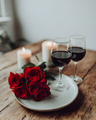 Romantic dinner with red roses and wine cozy home setting elegant mood