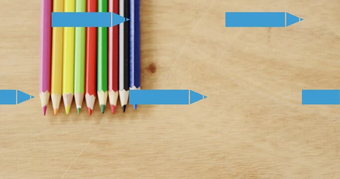 Animation of blue pencils moving over coloured pencils on school desk