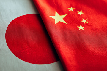 National flags of Japan and China illustrating political confrontation and international disputes.